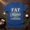 Blue t-shirt with "FAT Means Flavor THEN I'M F#%*CKING DELICIOUS" text in vintage style fonts and yellow border
