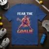 Lacrosse goalie wearing protective gear and holding a stick, text "FEAR THE GOALIE" on a blue t-shirt