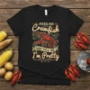 Feed Me Crawfish And Tell Me I'm Pretty text with a red crawfish graphic on a black t-shirt