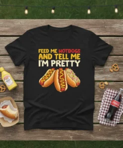 Feed Me Hotdogs And Tell Me I'm Pretty quote on a black t-shirt with illustrations of three hot dogs