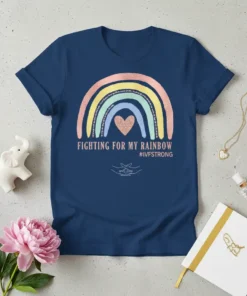 Navy blue t-shirt with a pastel rainbow graphic and rose gold heart, text reads "FIGHTING FOR MY RAINBOW #IVFSTRONG" with