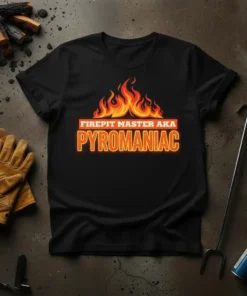 Black t-shirt with bold orange and yellow text "FIREPIT MASTER AKA PYROMANIAC" above a graphic of flames