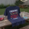 Navy blue t-shirt with white, yellow, and red text reading "FIREWORKS ARE NOT THE ONLY THING GETTING LIT TODAY" with