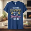 First Time Grandma Let The Spoiling Begin quote with baby footprints graphic on a navy blue t-shirt