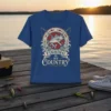 Fishing Is My Country quote with a jumping fish and crossed fishing rods graphic on a blue t-shirt
