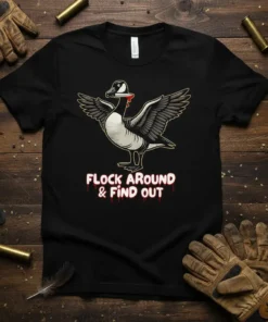 Goose with knife in mouth and wings spread, text "FLOCK AROUND & FIND OUT" below, on a black t-shirt