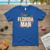Florida Man T-Shirt with a distressed white and orange text design, featuring a green alligator and palm trees