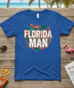 Florida Man T-Shirt with a distressed white and orange text design, featuring a green alligator and palm trees
