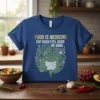 Blue t-shirt with "FOOD IS MEDICINE EAT GOOD FEEL GOOD BE GOOD" text and a graphic of the digestive system