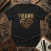 Black t-shirt with "FRANK" in textured gold font above a steampunk heart made of gears and cogs