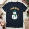 Cute snowman with 'Free Hugs' text, wearing a green hat and scarf, on a navy blue t-shirt design for Christmas