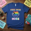 Free Mom Hugs t-shirt with a rainbow heart held by hands, celebrating LGBTQ+ pride and maternal love