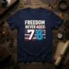 FREEDOM NEVER-AGES 76 text with American flag graphic on navy t-shirt