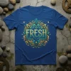 Blue t-shirt with the word FRESH in ornate gold and teal lettering, surrounded by decorative elements