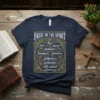 Fruit of the Spirit t-shirt design featuring Galatians 5:22-23 verses in ornate gold lettering on navy fabric