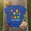 Fruity Friends t-shirt design featuring a grid of cute, smiling cartoon fruits including an orange, plum, pear, pomegranate, kiwi, lemon