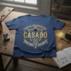 T-shirt with "Fruto Prohibido Casado Mantenga Su Distancia" text in gold and shield design