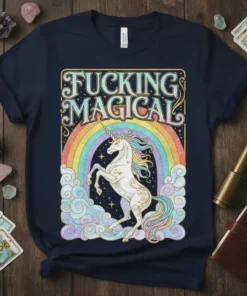 Fucking Magical t-shirt with a white unicorn rearing in front of a pastel rainbow and clouds, featuring bold typography