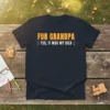 Black t-shirt with "FUN GRANDPA YES, IT WAS MY IDEA" in bold yellow and red text, featuring lightbulb graphics