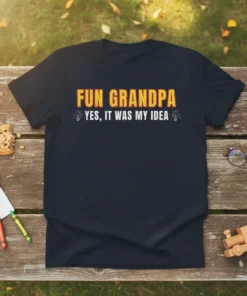 Black t-shirt with "FUN GRANDPA YES, IT WAS MY IDEA" in bold yellow and red text, featuring lightbulb graphics