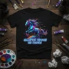 Galloping Through The Cosmos text with a vibrant, abstract horse graphic in neon colors on a black t-shirt