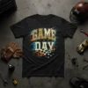 Black t-shirt with "GAME DAY" text in distressed gold and blue, with a checkered flag graphic and racing-inspired streaks