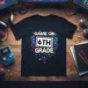 Game On 6th Grade text and gaming console graphic on a black t-shirt design