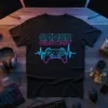 Black t-shirt with neon blue and pink "GAMER HEARTBEAT" text above a gamepad controller icon integrated into a heartbeat line
