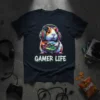 GAMER LIFE text with a colorful guinea pig wearing headphones and holding a video game controller on a dark t-shirt