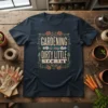 Gardening is my Dirty Little Secret quote on a dark navy t-shirt with floral and gardening tool graphics