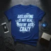 Gaslighting Is Not Real You're Just Crazy quote in bold white font on a blue t-shirt, surrounded by digital circuit