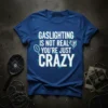 Gaslighting Is Not Real You're Just Crazy quote on a blue t-shirt, featuring a magnifying glass and brain graphic