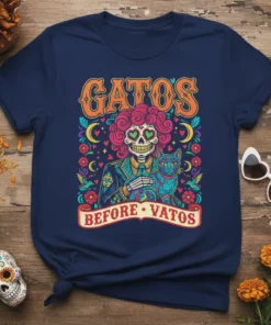 Gatos Before Vatos t-shirt design featuring a skeleton embracing a cat, with Day of the Dead inspired artwork and bold