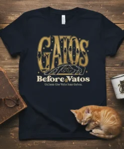 Gatos Before Vatos Unless the Vato has Gatos quote on a navy t-shirt, with gold distressed typography and cat graphics