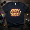Gold lettering spelling GAY SON with pink neon glow on a navy t-shirt, representing gay pride
