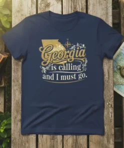 Georgia is calling and I must go quote on a navy blue t-shirt with a gold map outline and compass