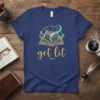 Get lit VOLUME I t-shirt design featuring an open golden book with gears and teal swirls, perfect for book lovers
