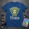 Graphic t-shirt featuring a stylized golden Medusa head with snakes for hair and the text "GET STONED" below