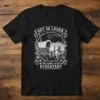 Black t-shirt with "Get In Loser. We're Going To Die Of Dysentery" text and vintage western wagon and bull graphic