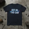 Navy blue t-shirt with "GET IN THE CAR" text and a retro car outline graphic in blue neon style
