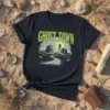Ghost Town T-Shirt with a vintage western scene featuring buildings and a water tower under a full moon