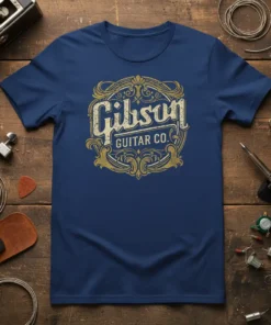 Gibson Guitar Co. vintage logo text design on a navy blue t-shirt, featuring ornate golden embellishments