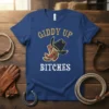 Giddy Up Bitches t-shirt featuring a gold cowboy hat and red cowboy boots graphic with white text