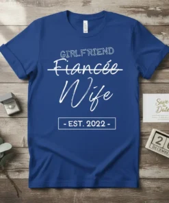 Girlfriend Fiancee Wife Est 2022 t-shirt design with white text and a crossed-out "Girlfriend" and "Fiancee" to highlight "Wife"