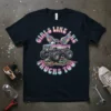 Girls Like Big Trucks Too text with a winged monster truck graphic on a navy t-shirt