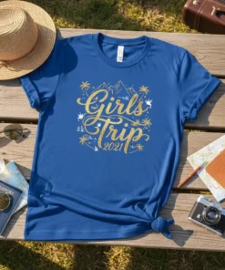 Girls Trip 2021 text with palm trees and mountains graphic on a blue t-shirt