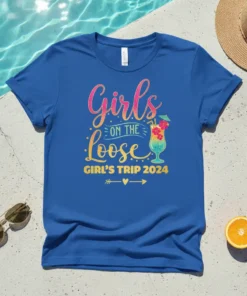 Girls on the Loose Girl's Trip 2024 text with tropical cocktail graphic on a blue t-shirt