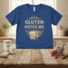 Gluten Hates Me text with angry bread graphic on a blue t-shirt, wheat stalks, and a red X