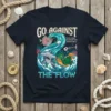 Christian t-shirt with "GO AGAINST THE FLOW" text and ocean wave graphic featuring fish and a hammerhead shark. Includes Romans