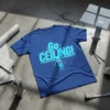 Blue t-shirt with "Go CEILING!" text and circuit board design, featuring an upward arrow